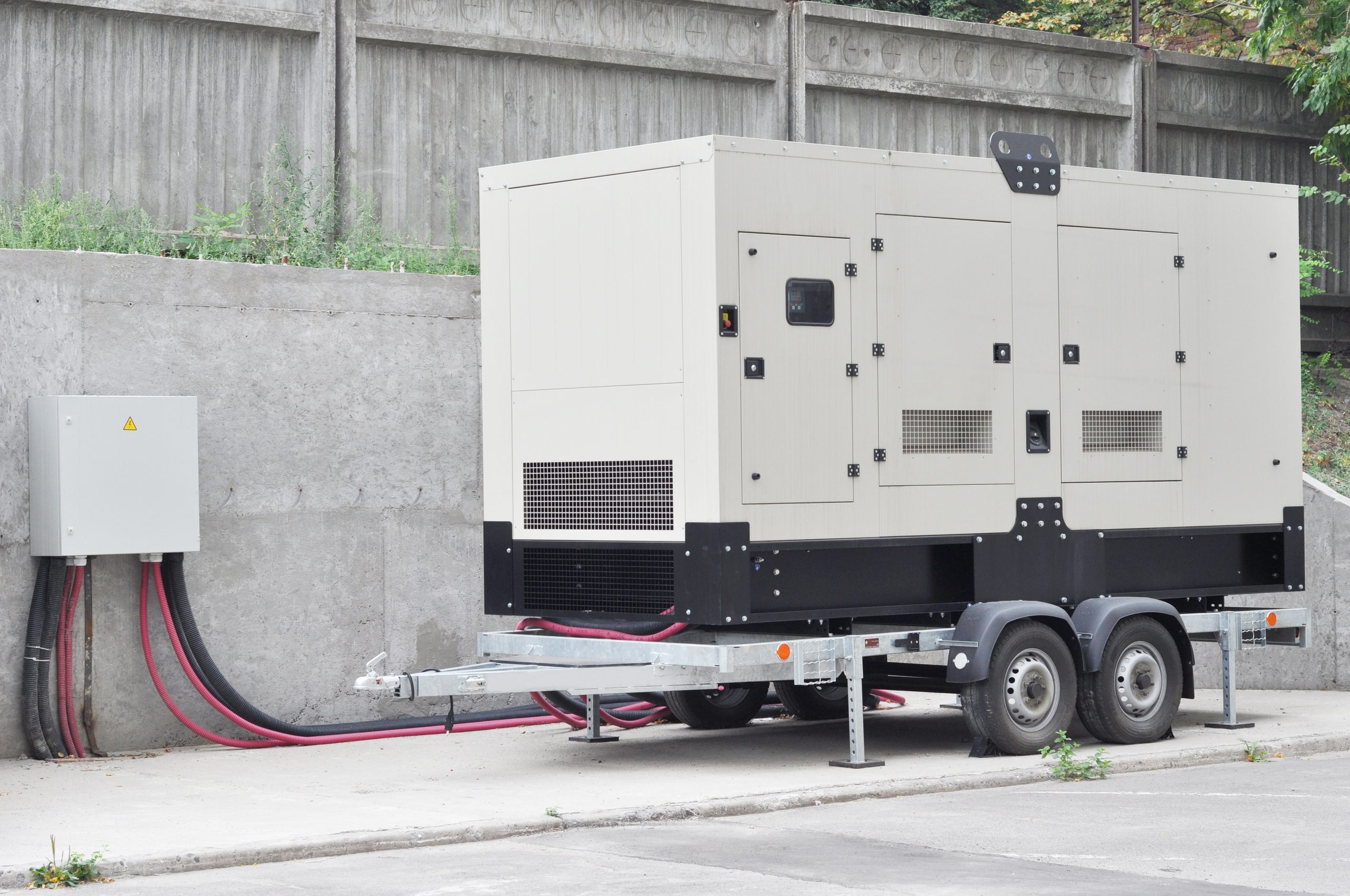 Industrial Diesel Generator. Standby generator. Industrial Diesel Generator for Office Building connected to the Control Panel with Cable Wire. Backup Generator Power.